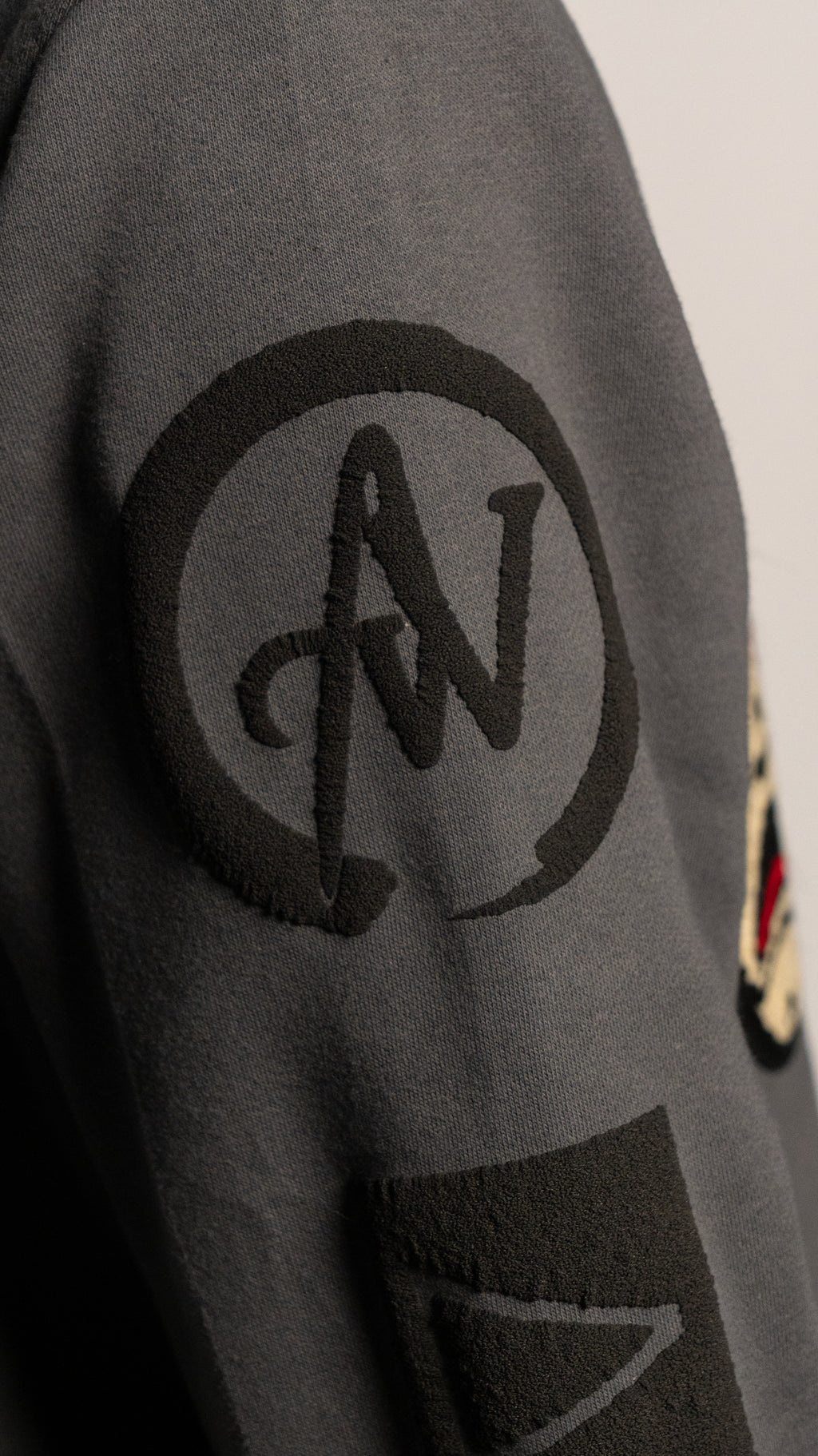 Gray sweatshirt with A2W logo on the sleeve against a neutral background
