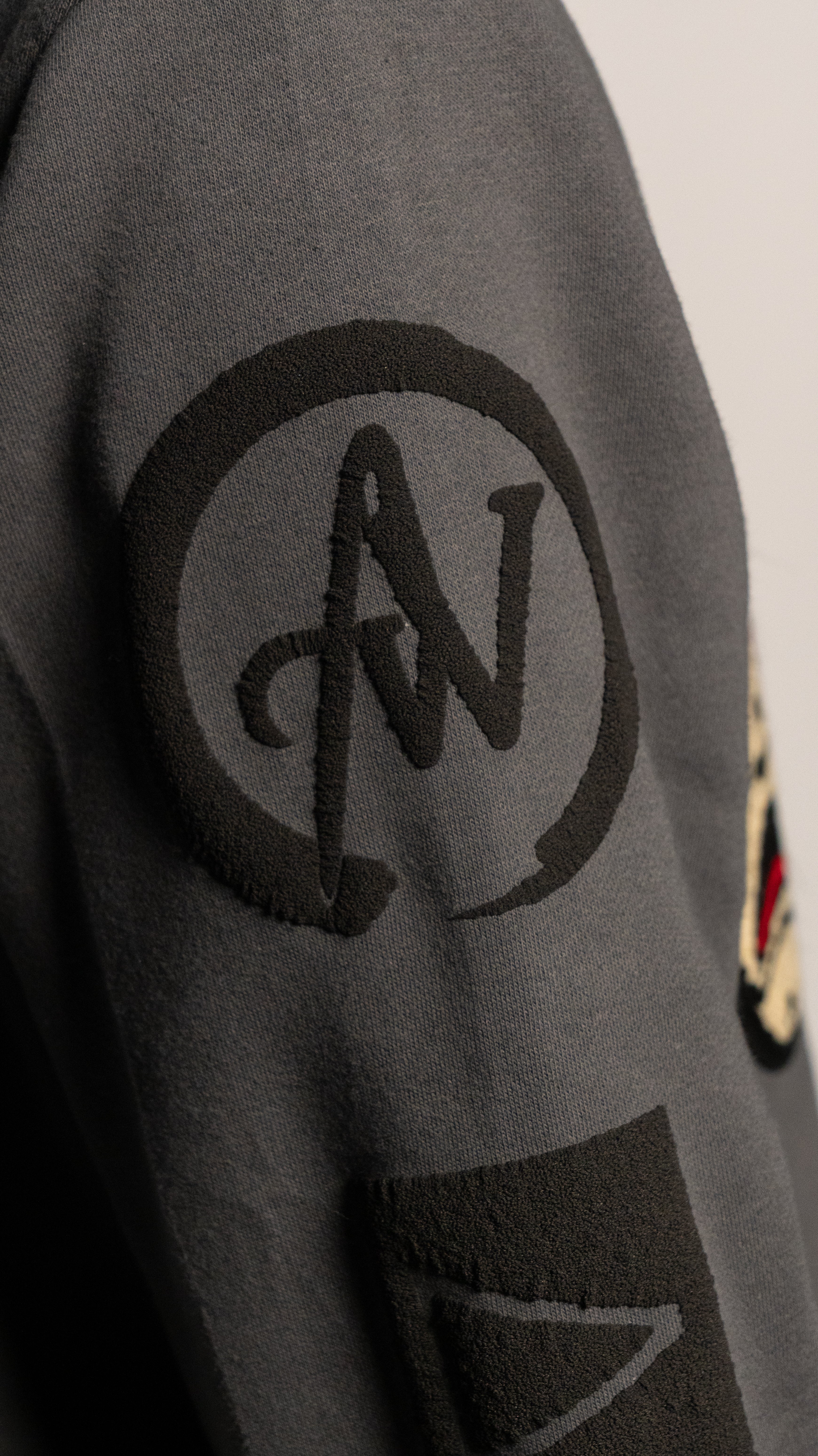 Gray sweatshirt with A2W logo on the sleeve against a neutral background