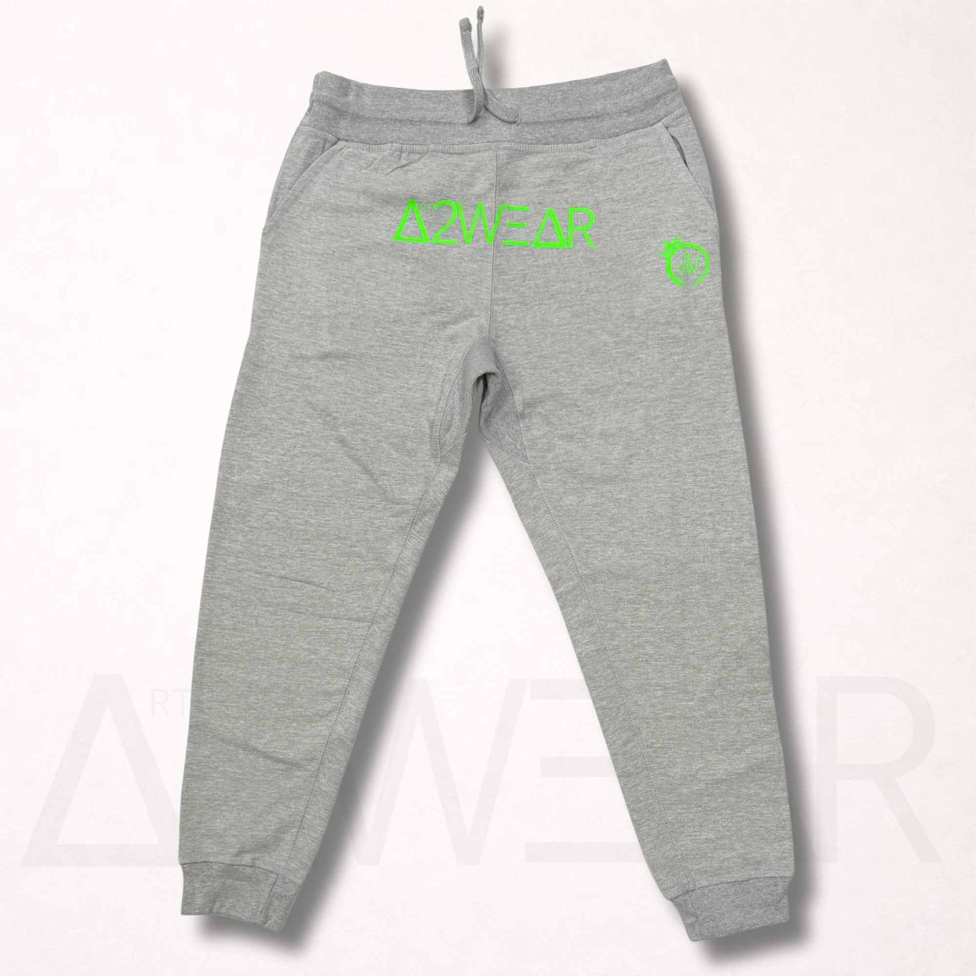 Gray sweatpants with green branding on a white background