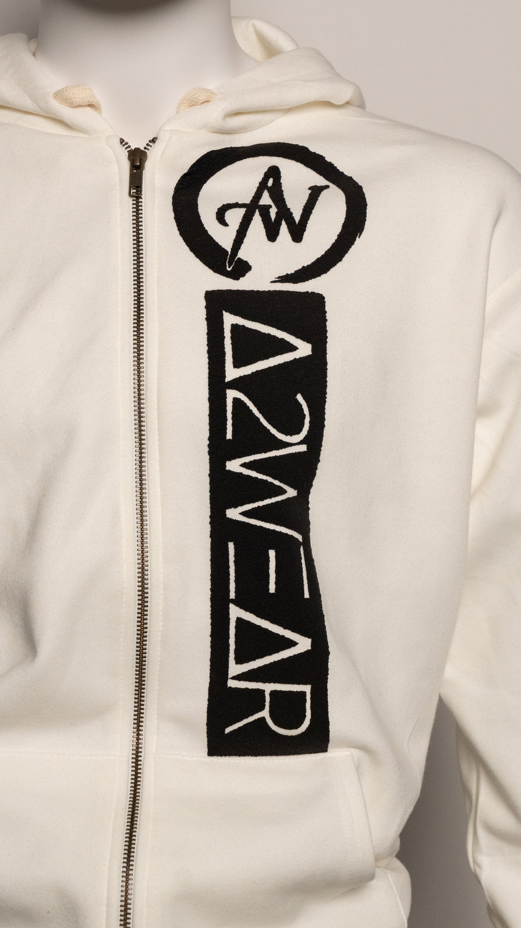 Cream hoodie with black logo and text on a neutral background