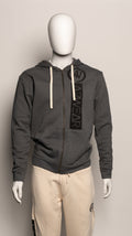 Dark gray hoodie with a brand logo on a mannequin against a beige background
